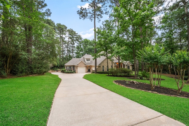 1924 Boulder Ridge Dr, Conroe, TX 77304 - view of front of house with concrete driveway, a front lawn, and a garage