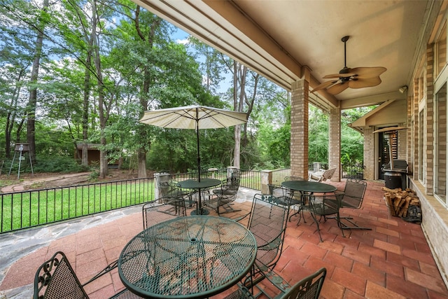 1924 Boulder Ridge Dr, Conroe, TX 77304 - view of patio / terrace featuring outdoor dining space, ceiling fan, and view of scattered trees