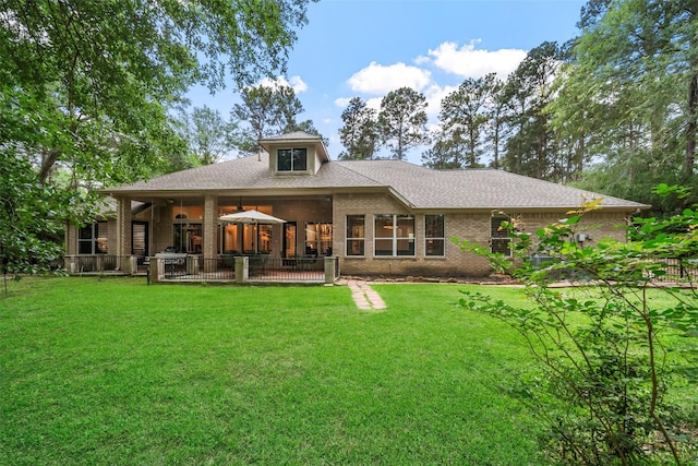 1924 Boulder Ridge Dr, Conroe, TX 77304 - back of house with a yard, a patio area, brick siding, and a shingled roof