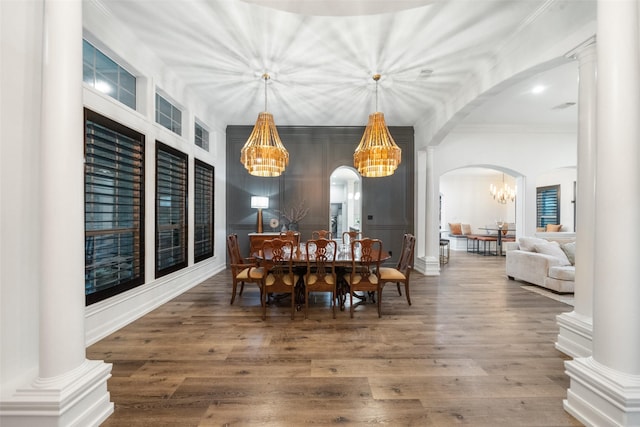 1924 Boulder Ridge Dr, Conroe, TX 77304 - dining space with a chandelier, arched walkways, ornamental molding, and wood finished floors