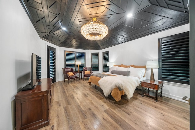 1924 Boulder Ridge Dr, Conroe, TX 77304 - bedroom with a chandelier, wood finished floors, and baseboards