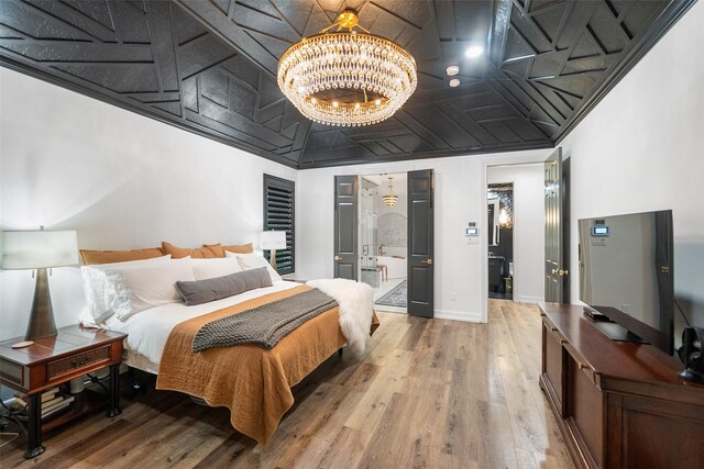 1924 Boulder Ridge Dr, Conroe, TX 77304 - bedroom featuring a chandelier, wood finished floors, baseboards, and an ornate ceiling
