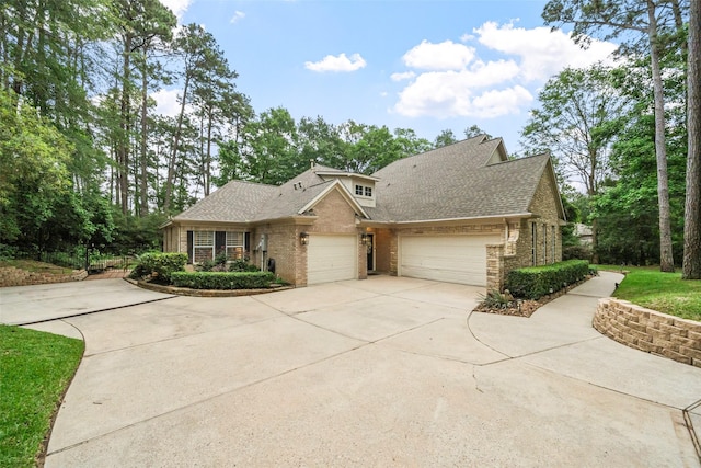1924 Boulder Ridge Dr, Conroe, TX 77304 - view of front facade with a garage, driveway, brick siding, and roof with shingles