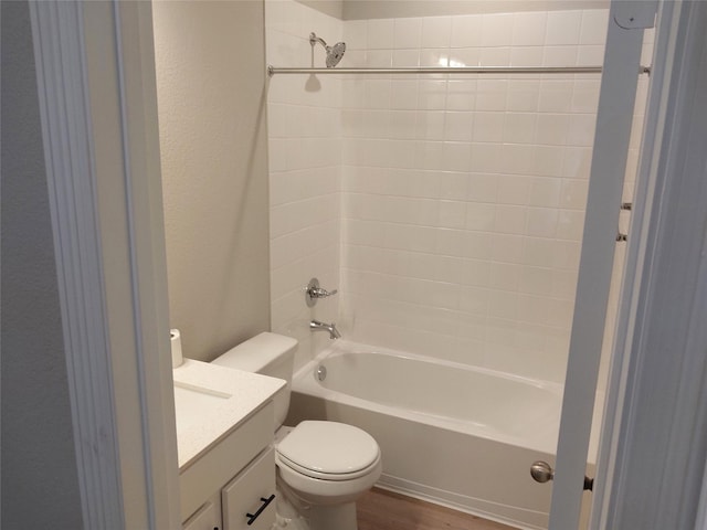 full bathroom featuring toilet, shower / tub combination, a textured wall, vanity, and wood finished floors