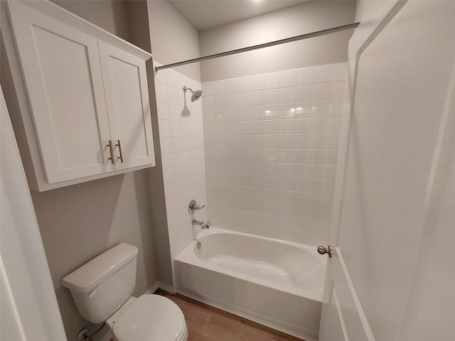 full bathroom featuring toilet, wood finished floors, and bathtub / shower combination