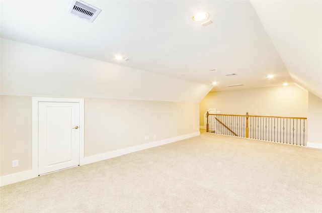 additional living space featuring vaulted ceiling, carpet, baseboards, and recessed lighting