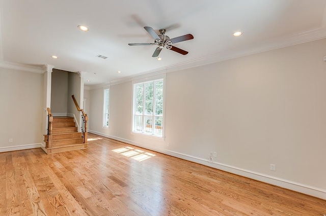unfurnished living room with crown molding, recessed lighting, stairway, baseboards, and ceiling fan