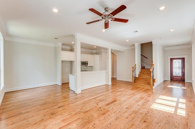 unfurnished living room featuring ornamental molding, recessed lighting, baseboards, light wood-type flooring, and a ceiling fan
