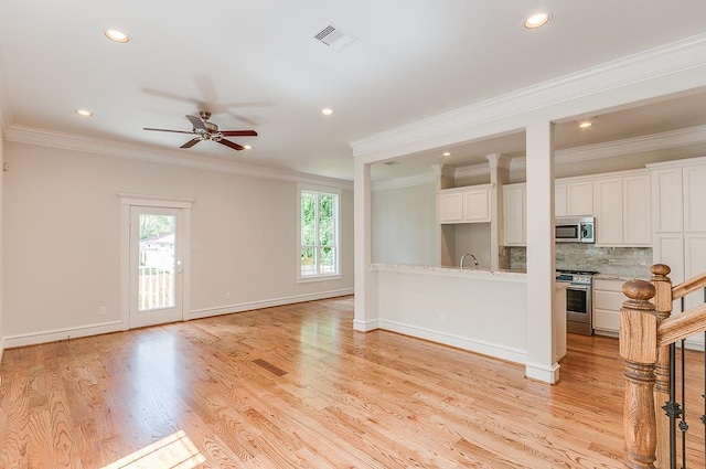 unfurnished living room featuring ceiling fan, ornamental molding, recessed lighting, light wood-style flooring, and baseboards