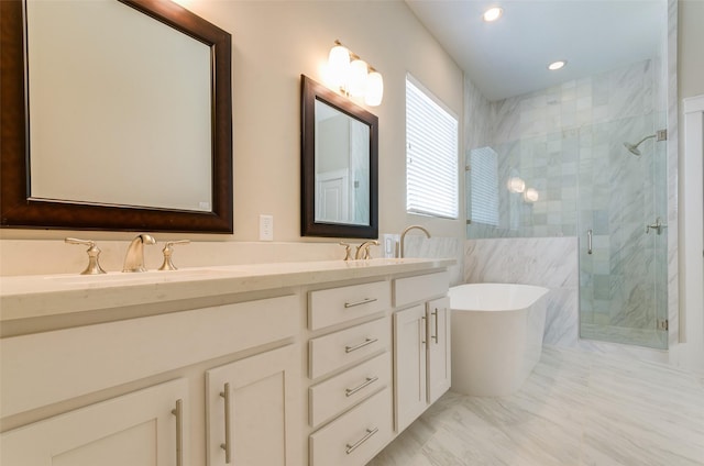bathroom with a stall shower, a freestanding bath, double vanity, and recessed lighting