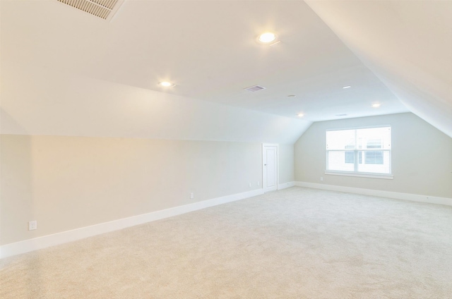 additional living space featuring lofted ceiling, light carpet, baseboards, and recessed lighting