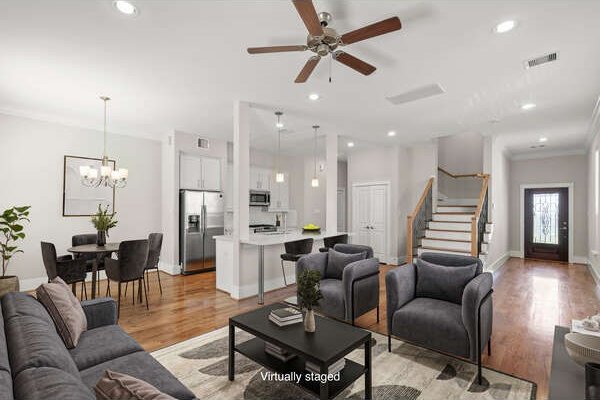 1814 Napa Creek Ln, Houston, TX 77009 - living area with stairway, light wood-type flooring, ceiling fan, recessed lighting, and a chandelier