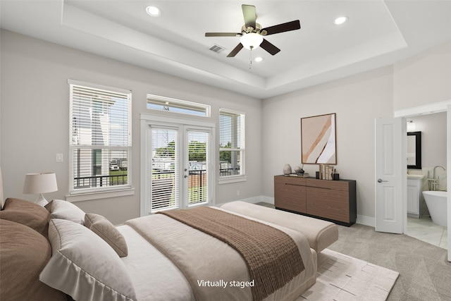 1814 Napa Creek Ln, Houston, TX 77009 - bedroom featuring a tray ceiling, access to outside, light colored carpet, recessed lighting, and french doors