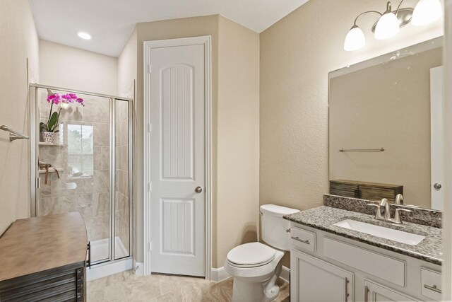 514 Pearl View Ln, Pinehurst, TX 77362 - bathroom featuring a shower stall, toilet, vanity, baseboards, and a textured wall