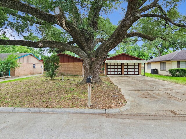 807 Golf Ct, Stafford, TX 77477 - mid-century inspired home featuring central AC unit, driveway, and brick siding