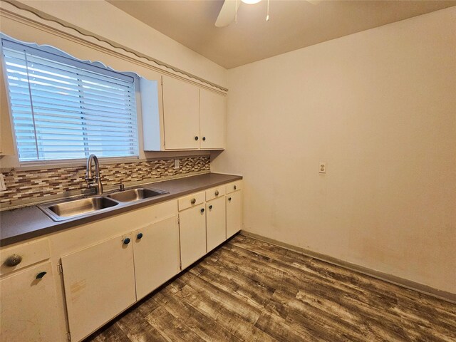 807 Golf Ct, Stafford, TX 77477 - kitchen with a sink, ceiling fan, dark countertops, and decorative backsplash
