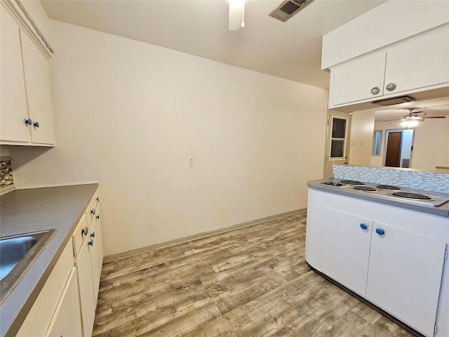 807 Golf Ct, Stafford, TX 77477 - kitchen featuring ceiling fan, light wood-style floors, white cabinets, stovetop, and a sink