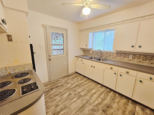 807 Golf Ct, Stafford, TX 77477 - kitchen with a sink, light wood-style floors, backsplash, a ceiling fan, and range