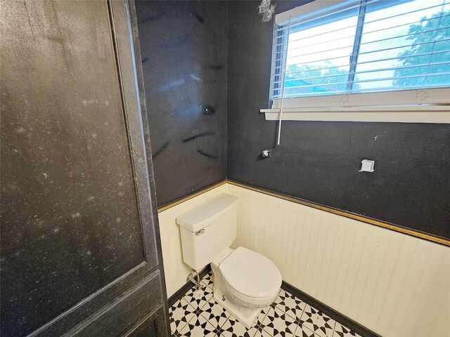 807 Golf Ct, Stafford, TX 77477 - bathroom featuring toilet, wainscoting, and tile patterned floors