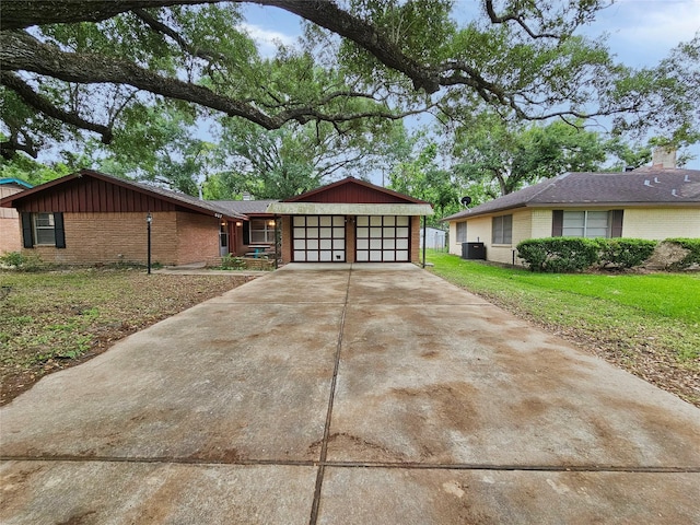 807 Golf Ct, Stafford, TX 77477 - view of front of home featuring brick siding, an attached garage, concrete driveway, and central AC
