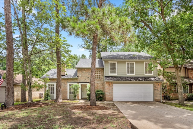 65 Hickory Oak Dr, The Woodlands, TX 77381 - view of front of house with brick siding, a garage, driveway, and a shingled roof