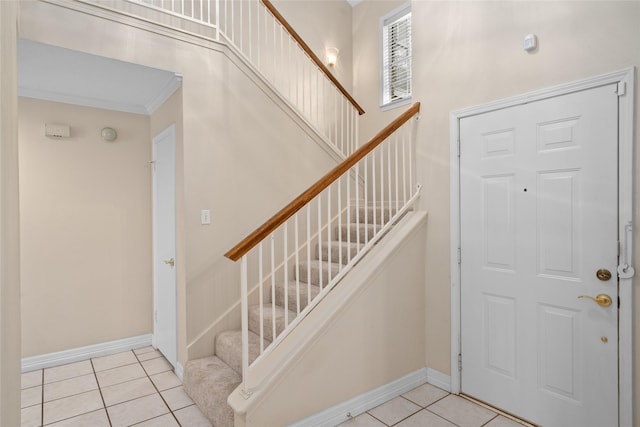 65 Hickory Oak Dr, The Woodlands, TX 77381 - tiled foyer featuring stairs, baseboards, and ornamental molding