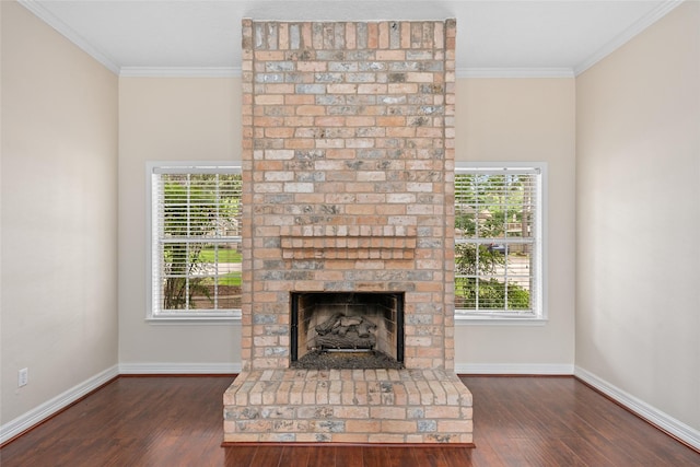 65 Hickory Oak Dr, The Woodlands, TX 77381 - unfurnished living room with ornamental molding, dark wood-style floors, baseboards, and a brick fireplace