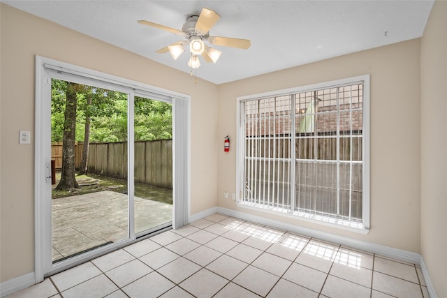 65 Hickory Oak Dr, The Woodlands, TX 77381 - doorway to outside featuring baseboards, light tile patterned floors, and a ceiling fan