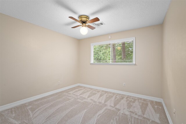 65 Hickory Oak Dr, The Woodlands, TX 77381 - spare room featuring a ceiling fan, baseboards, carpet floors, and a textured ceiling