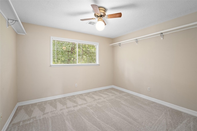65 Hickory Oak Dr, The Woodlands, TX 77381 - carpeted spare room with ceiling fan, baseboards, and a textured ceiling