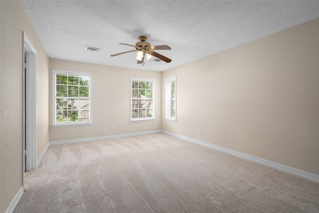 65 Hickory Oak Dr, The Woodlands, TX 77381 - unfurnished room with a ceiling fan, light colored carpet, baseboards, and a textured ceiling