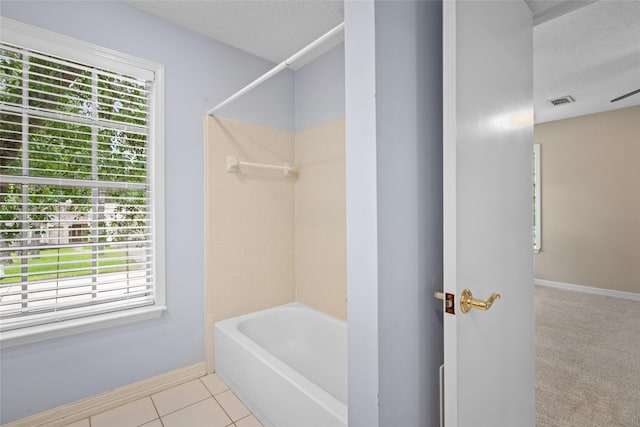 65 Hickory Oak Dr, The Woodlands, TX 77381 - bathroom featuring plenty of natural light, washtub / shower combination, baseboards, and a textured ceiling