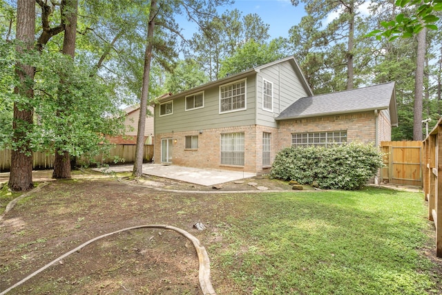 65 Hickory Oak Dr, The Woodlands, TX 77381 - rear view of house featuring brick siding and a patio area