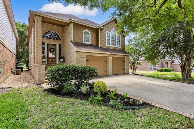 170 April Cv, Montgomery, TX 77356 - traditional-style house featuring brick siding, roof with shingles, an attached garage, and concrete driveway