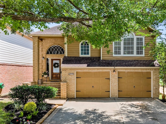 170 April Cv, Montgomery, TX 77356 - view of front of home with an attached garage, driveway, a shingled roof, and brick siding
