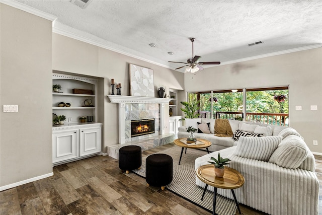 170 April Cv, Montgomery, TX 77356 - living room with dark wood-style floors, a ceiling fan, crown molding, a textured ceiling, and a high end fireplace