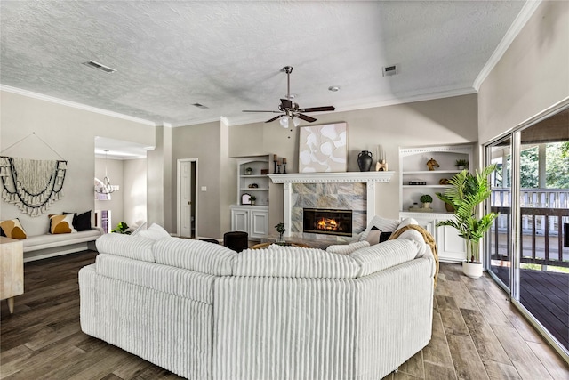 170 April Cv, Montgomery, TX 77356 - living room with wood finished floors, a premium fireplace, a ceiling fan, crown molding, and a textured ceiling