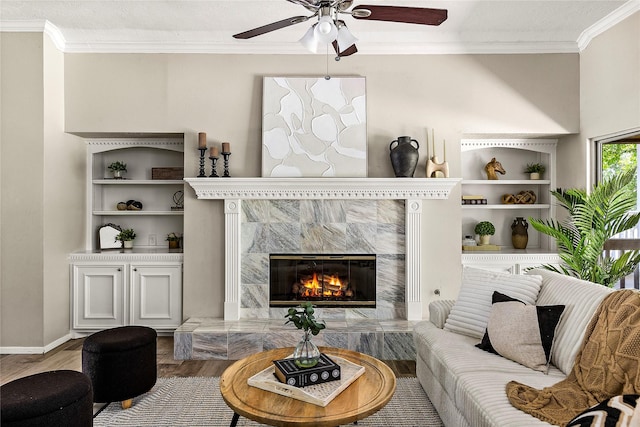 170 April Cv, Montgomery, TX 77356 - living room featuring ornamental molding, a ceiling fan, wood finished floors, and a premium fireplace