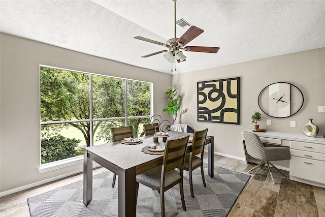 170 April Cv, Montgomery, TX 77356 - dining room featuring a textured ceiling, wood finished floors, a ceiling fan, baseboards, and a desk