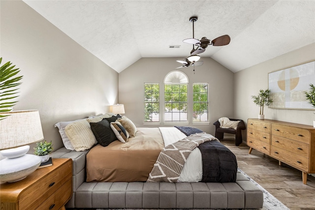 170 April Cv, Montgomery, TX 77356 - bedroom with wood finished floors, lofted ceiling, ceiling fan, and a textured ceiling