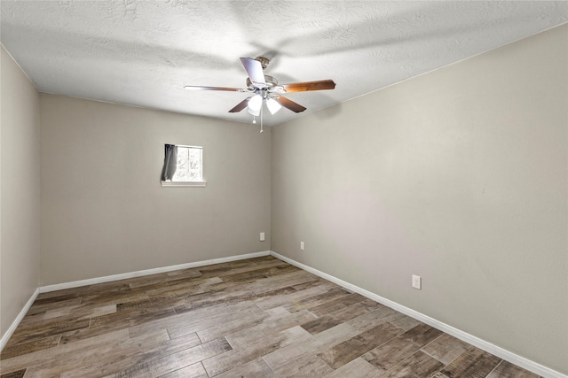 170 April Cv, Montgomery, TX 77356 - spare room with ceiling fan, wood finished floors, baseboards, and a textured ceiling