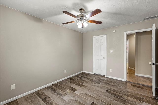 170 April Cv, Montgomery, TX 77356 - empty room featuring wood finished floors, ceiling fan, baseboards, and a textured ceiling