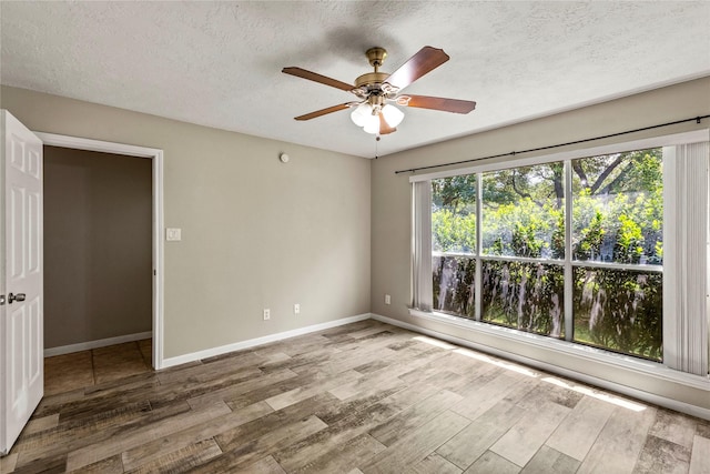 170 April Cv, Montgomery, TX 77356 - spare room featuring wood finished floors, ceiling fan, baseboards, and a textured ceiling