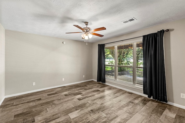 170 April Cv, Montgomery, TX 77356 - unfurnished room with wood finished floors, ceiling fan, a textured ceiling, and baseboards