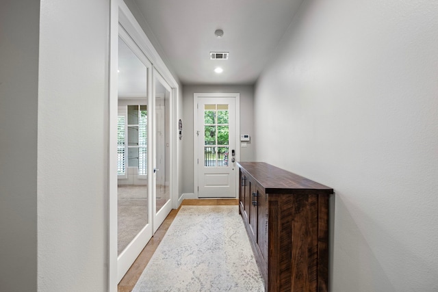 doorway to outside with light wood-type flooring, baseboards, and french doors