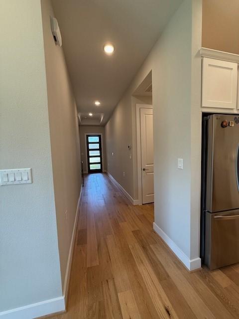 18714 Sweetwater Springs Dr, Cypress, TX 77433 - hallway with light wood finished floors, baseboards, and recessed lighting