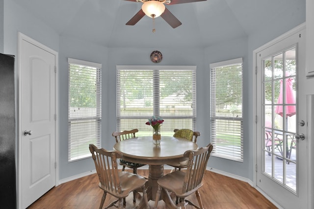 dining room featuring healthy amount of natural light, wood finished floors, lofted ceiling, and a ceiling fan