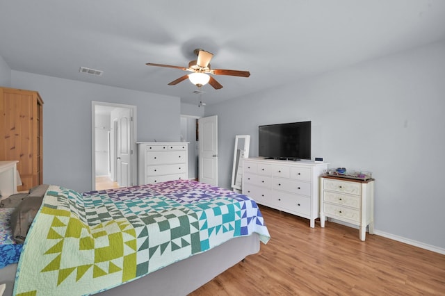 bedroom with wood finished floors, baseboards, and ceiling fan