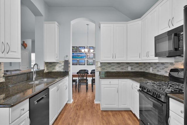 kitchen with black appliances, a sink, a chandelier, arched walkways, and white cabinetry