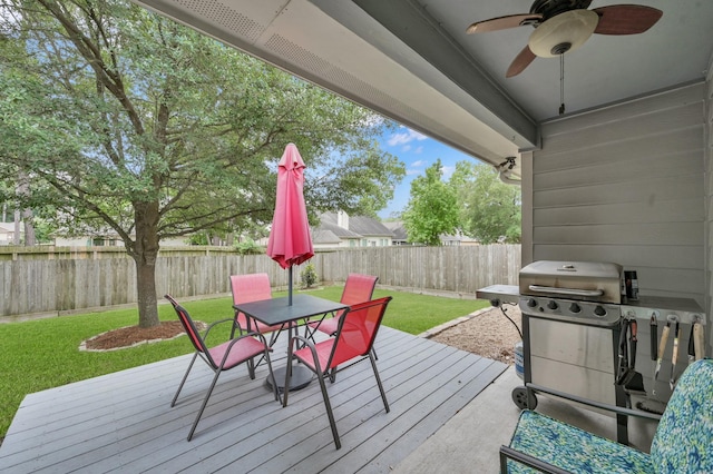 wooden deck with outdoor dining area, a ceiling fan, and grilling area